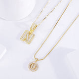 Ulla – elegant set med initialshalsband i guld med pavéstenar